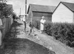 City Cleanup campaign. Dr. and Mrs. Henry E. Stout and Grandson, Sidney Stout II, shown in clean alley