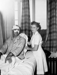 Patrolman E. C. Bradshaw shown with nurses aide Martha Renfro