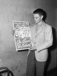 Robert Hull, 16, holding "Back to School" poster