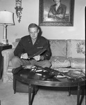 Lieutenant Dick Moncrief, looking at souvenirs from China