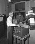 Tyler C. Greene operating a new postal machine