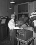 Tyler C. Greene, superintendent of Central Post Office Station, operating a new machine