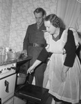Marine Wayne W. Williams watching his mother bake