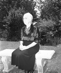 Mrs. M. R. Sanguinet sitting in her garden