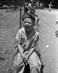 Fort Worth Recreation Department junior baseball league fielder Johnny Eddyhausen sitting on the sidelines