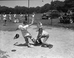 Fort Worth Recreation Department junior baseball league player Billy Davenport, sliding into home base