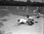 Fort Worth Recreation Department junior baseball league player Billy Davenport, sliding into home base