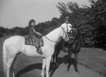 Merle Stanton and daughter riding horses