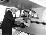 Civil Air Patrol. John B. Collier Junior handing package to Lieutenant Cecil Black
