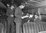 Military Policemen. Unidentified soldier checking travel orders