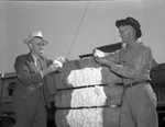 H. G. Parr, left, buying bale of cotton