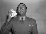 A sneezing M. B. Rudman, president of the Texas Hay Fever Suffers Association