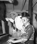 Gary Cooper and unidentified man at a piano at Amon Carter's Shady Oak Farm