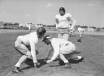 Texas Christian University football line coach Mike Brumbelow with players