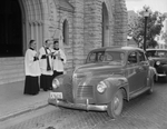 Reverend Ernest Langenhorst blessing an automobile