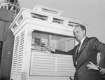 Meterologist H. P. Adams shown with the new theromometer at the Weather Bureau.