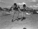Polytechnic High School football tacklers Orville Lyles (left) and Reese Moeller