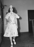 Miss Dorothy Oyervides, wearing a dress made from newspapers