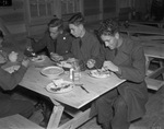 Military training at Camp Bowie, Brownwood, Texas, World War II; men of Company D at mess hall, from left, Private First Class Clinton E. Canady, Private Joe Martin, and Private Charlie Wilson