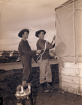 Camp Bowie, Brownwood, Texas, World War II; Texas National Guard, Private Odell Elrod and Private Raymond Moore of Company B, 142nd Infantry, lacing down top of their tent