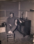 Camp Bowie, Brownwood, Texas, World War II; Texas National Guard, First Sgt. O.A. Carroll of Company B 142nd, tunes in dance band on company's new radio-phonograph