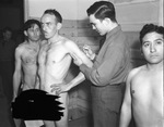 R.W. Isbell gets smallpox vaccination from Private K.M. Kressenberg