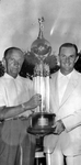 S.M. "Bing" Bingham presents The Founder's Day trophy to Royal Hogan