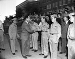 Amon Carter Jr. shown presenting team championship trophy to Cadet Major Jimmy Vickery, captain of the city's top ROTC rifle team at Poly High
