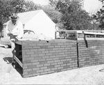 Harry E. Brants builds a brick wall