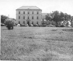 Cook Hospital with view of lawn and 1940-50's era cars