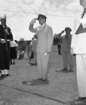 General Douglas MacArthur flashes a famous salute at Farrington Field