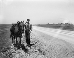 Tom Cashner of Canton, Ohio, shown by horse as he paused for drink of water on his 1,300 mile horseback ride from Canton to Dallas