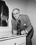 Portrait of Milt Overman with Oscar award