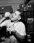 Dr. Willis G. Hewatt eating oyster