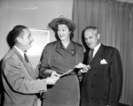 Miss Jo Kelly accepts checks from Dr. Ralph Ewing and Roy Tarwater