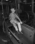 Ray Snider, double amputee, shown working in forge shop of American Manufacturing Company