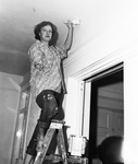 Mrs. G. E. Carpenter shown painting ceiling
