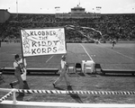 Unidentified boys carrying sign "Klobber the Kiddy Korps"