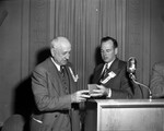 Amon Carter being awarded honorary letter and membership in the TCU Ex-Lettermen's Association at the annual homecoming banquet at Hotel Texas