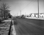 Workers completing the last strip of asphalt covering on Sylvania Street, Fort Worth, Texas