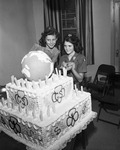 Girl Scouts. Brownie Kathleen Sparks and Sharron McKay shown with huge Scout birthday cake