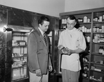 Fair Oaks Shopping Center. Ralph Wynne, pharmacist, and Wayne R. Hill, manager of Skillern's shown examining a carton of vaccines