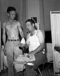 Lowell E. Smitherman, left, and Melvin Blair compare notes on their injuries