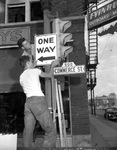 Leslie Reedy and F. R. Greer installing one-way street signs, Fort Worth, Texas