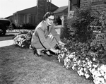 Fort Worth, City of Residences. Mrs. Thomas Elliott in her yard at 1700 Oakland Boulevard