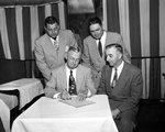 Mayor Edwards signs a proclamation as "Pay Your Poll Tax Early" week as County Tax Assessor-Collector Reed Stewart, seated right, looks on. J. W. Beckham, and Jess Bowen