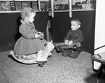 Barbara Beggs Simons andÂ Dana Barber playing with toys.