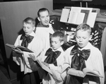 Three members of the Boys' Choir practice under Minister of Music Elza Cook