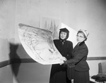 Mrs. Harry B. Friedman and Mrs. W. A. Hawkins with giant Christmas card