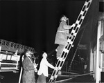 Fireman on ladder, two others at base of ladder; Star Arms Hotel, 108 West 15th Street, Fort Worth, Texas by Dub McPhail